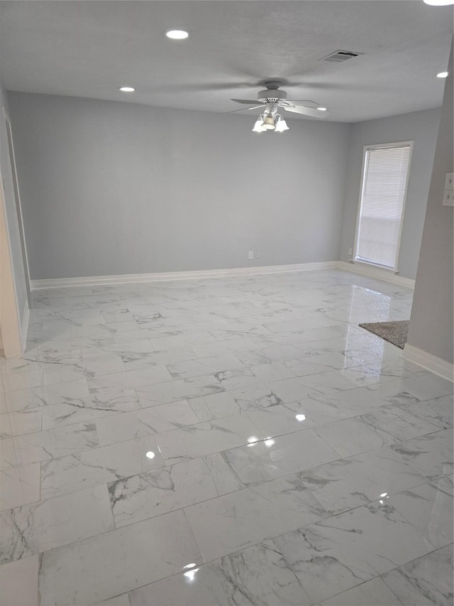 empty room with baseboards, marble finish floors, a ceiling fan, and recessed lighting