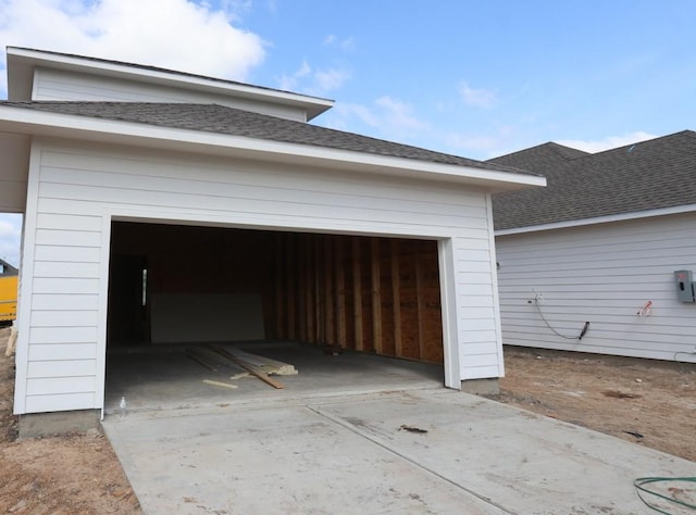 garage with concrete driveway