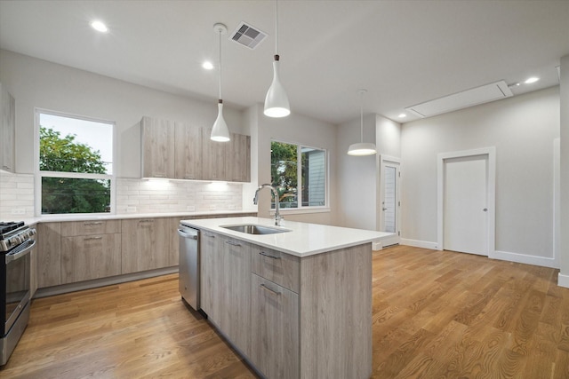 kitchen with visible vents, light brown cabinetry, appliances with stainless steel finishes, modern cabinets, and a sink