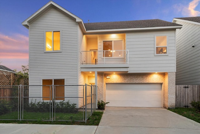 view of front of house featuring a fenced front yard, concrete driveway, a balcony, and brick siding