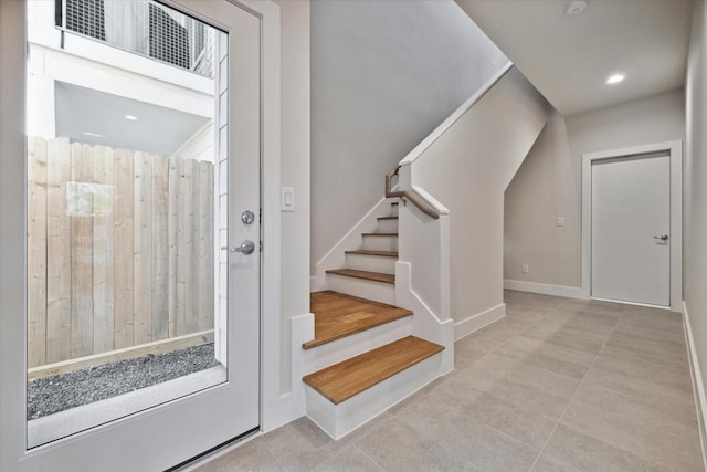 stairs featuring tile patterned floors, visible vents, and recessed lighting