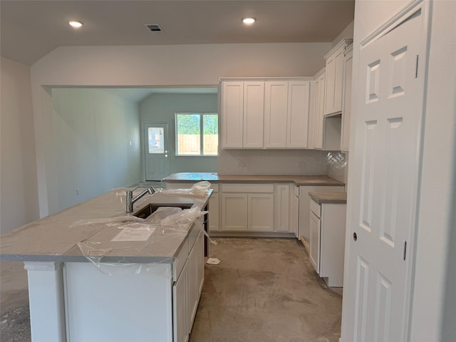19122 Hazel Firs Ln, Magnolia, TX 77355 - kitchen featuring a sink, an island with sink, white cabinetry, tasteful backsplash, and recessed lighting