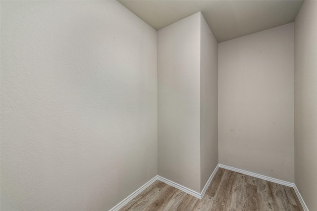 empty room with light wood-style floors and baseboards