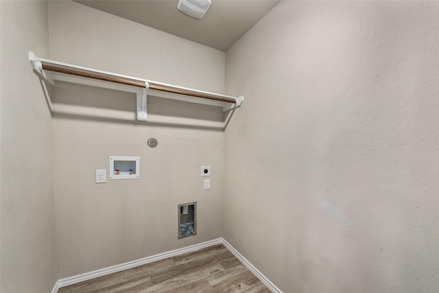 laundry area featuring electric dryer hookup, wood finished floors, baseboards, hookup for a washing machine, and laundry area