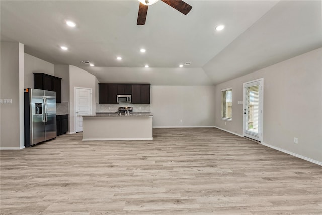 kitchen featuring a ceiling fan, stainless steel appliances, vaulted ceiling, light wood-style floors, and open floor plan