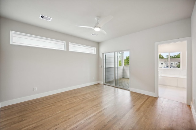 interior space with light wood-type flooring, visible vents, access to outside, and baseboards