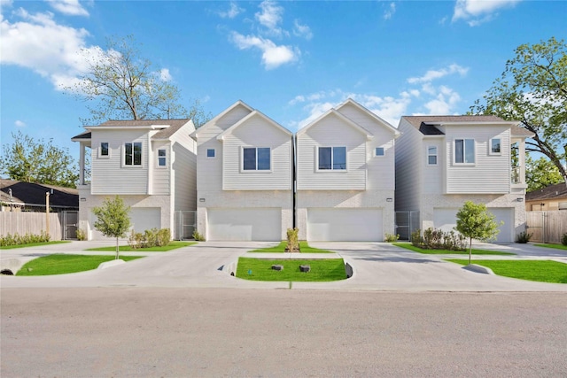 view of property featuring an attached garage, driveway, and fence