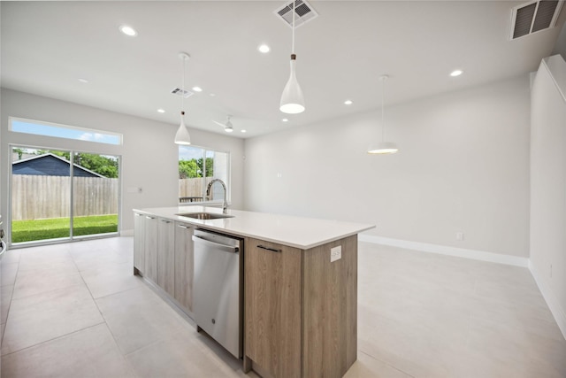 kitchen featuring stainless steel dishwasher, modern cabinets, visible vents, and a sink