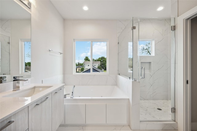 full bath featuring a bath, a wealth of natural light, a marble finish shower, and marble finish floor