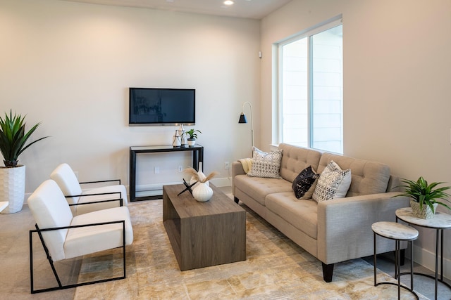 living area featuring baseboards and recessed lighting