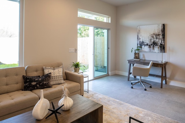 living area with baseboards and light tile patterned flooring