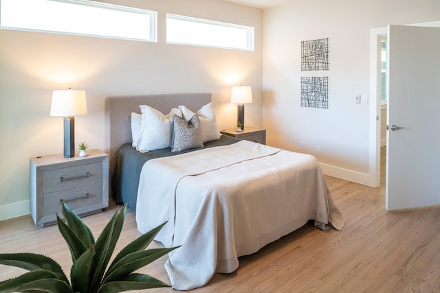 bedroom featuring baseboards and light wood-style floors