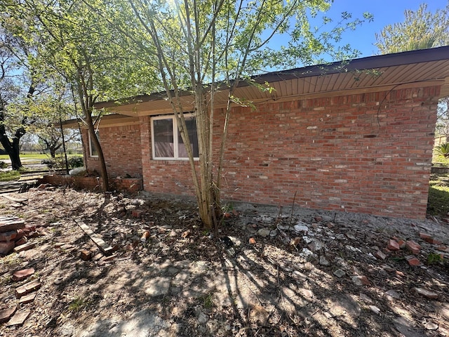 view of side of home featuring brick siding