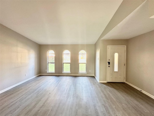 foyer with wood finished floors and baseboards