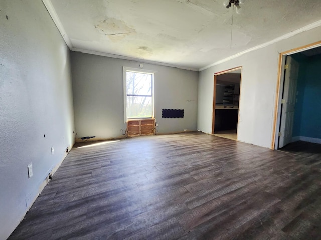 unfurnished living room with crown molding and wood finished floors