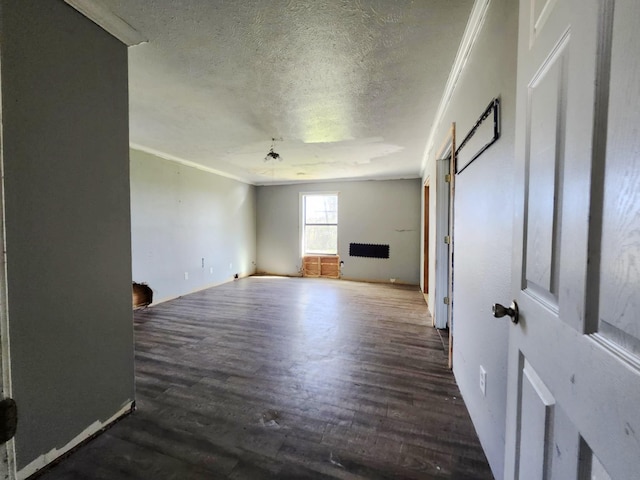 unfurnished living room featuring a textured ceiling, crown molding, and wood finished floors