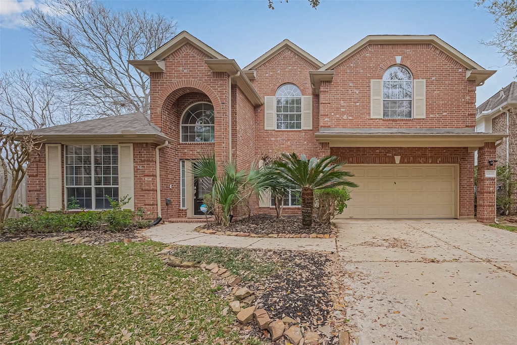 10635 Farmersville Frk, Missouri City, TX 77459 - traditional-style house with brick siding, an attached garage, and concrete driveway