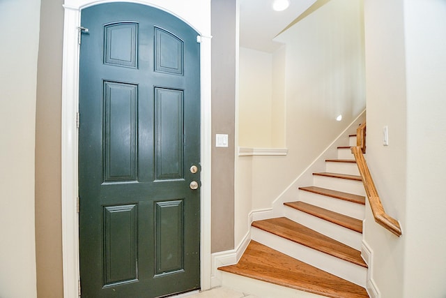 foyer with stairway and baseboards