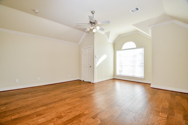 interior space featuring visible vents, lofted ceiling, wood finished floors, baseboards, and ceiling fan