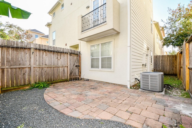 view of patio / terrace with central air condition unit and a fenced backyard