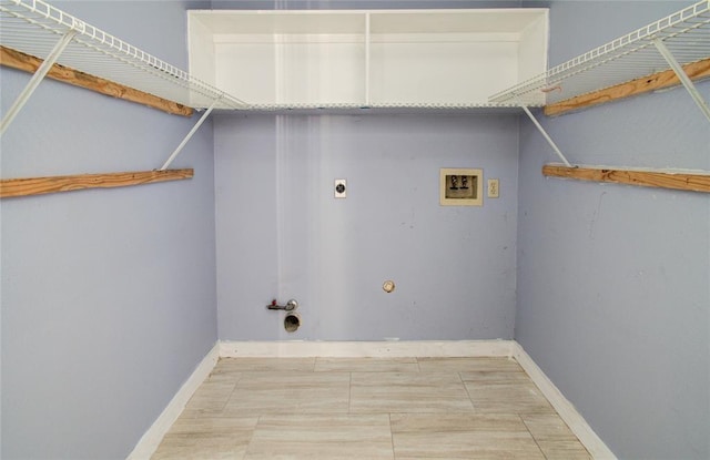 clothes washing area with baseboards, gas dryer hookup, laundry area, hookup for a washing machine, and electric dryer hookup