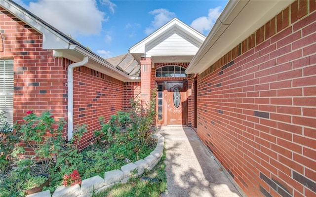 entrance to property featuring brick siding