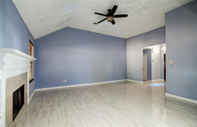 unfurnished living room with visible vents, a fireplace, baseboards, ceiling fan, and vaulted ceiling