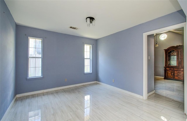 empty room featuring visible vents and baseboards