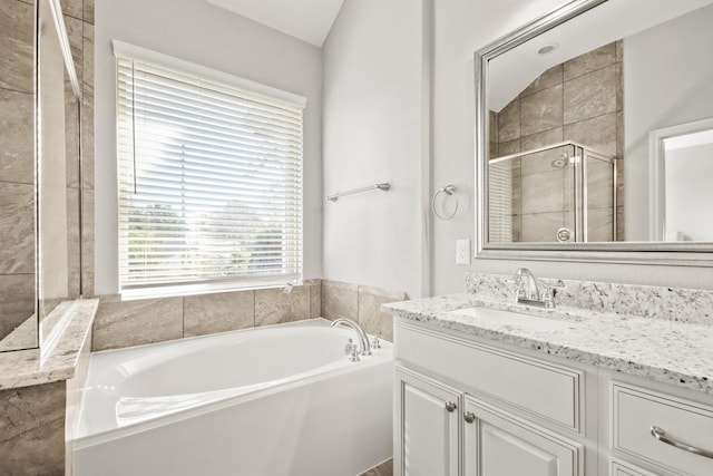 full bathroom with a shower stall, a garden tub, and vanity