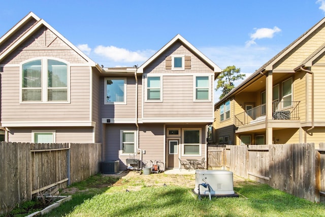 back of property with a lawn and a fenced backyard