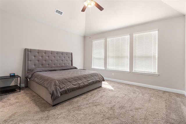 carpeted bedroom with vaulted ceiling, visible vents, baseboards, and ceiling fan