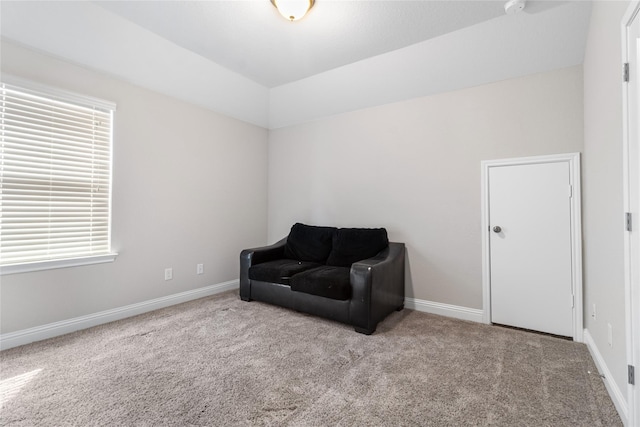 sitting room with baseboards, carpet floors, and lofted ceiling