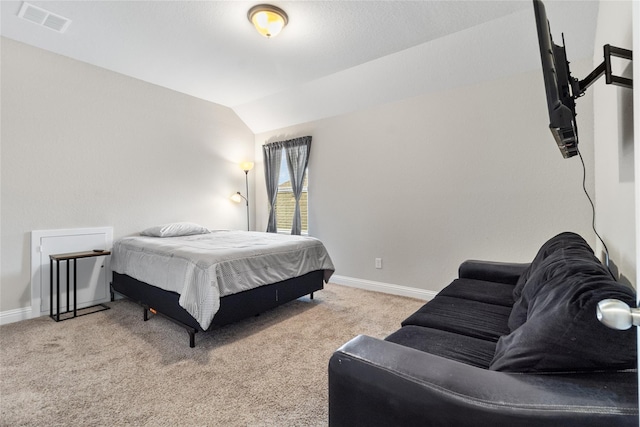 bedroom with vaulted ceiling, baseboards, visible vents, and carpet floors