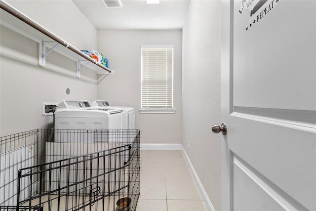 washroom featuring baseboards, visible vents, laundry area, tile patterned floors, and independent washer and dryer