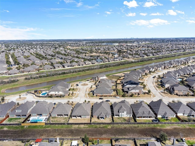 drone / aerial view featuring a residential view and a water view