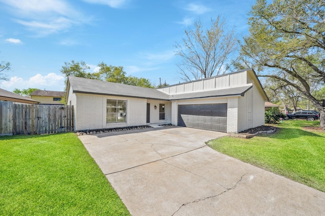 view of front facade with brick siding, a garage, and a front lawn