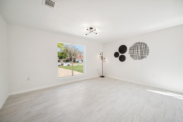 unfurnished room with visible vents and baseboards