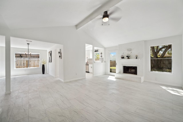 unfurnished living room with a fireplace, vaulted ceiling with beams, ceiling fan with notable chandelier, and baseboards