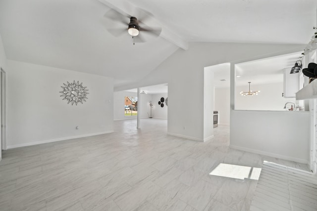 unfurnished living room featuring ceiling fan with notable chandelier, vaulted ceiling with beams, and baseboards