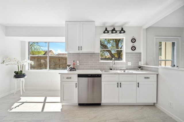 kitchen with decorative backsplash, dishwasher, white cabinetry, and a sink