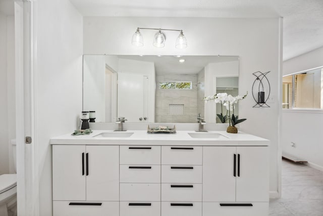 bathroom with a shower stall, toilet, marble finish floor, and a sink