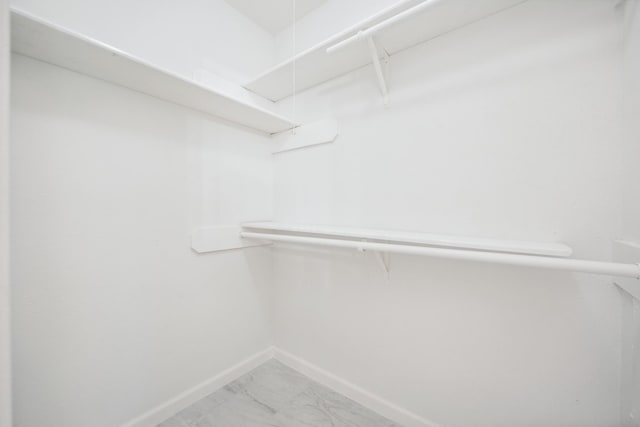 spacious closet with marble finish floor