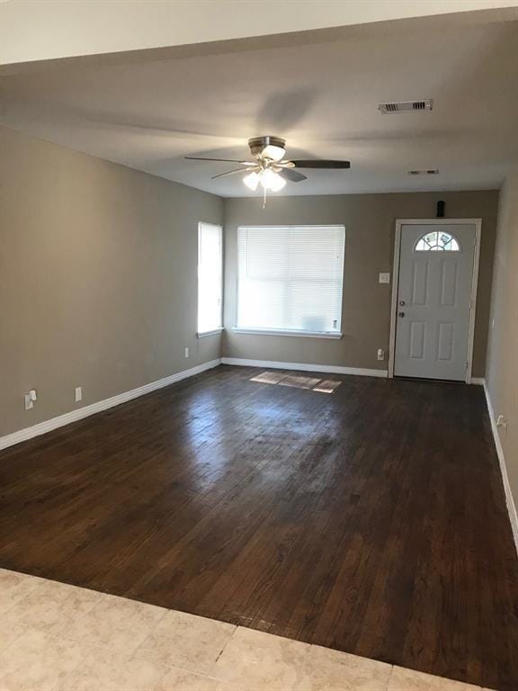 entryway featuring baseboards, visible vents, dark wood-style flooring, and ceiling fan