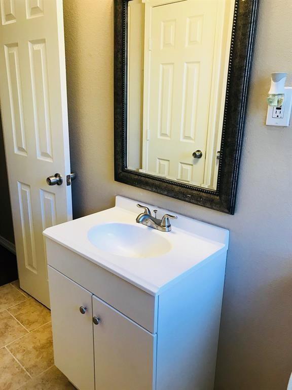bathroom with tile patterned floors and vanity