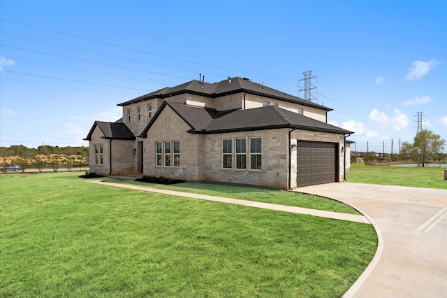 view of front of home featuring driveway, a front yard, a garage, and stone siding