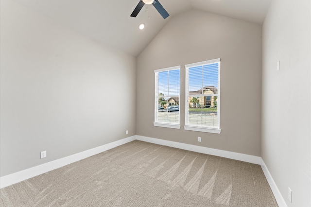 empty room featuring carpet floors, high vaulted ceiling, baseboards, and ceiling fan