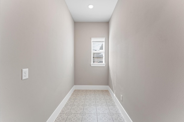 spare room featuring baseboards