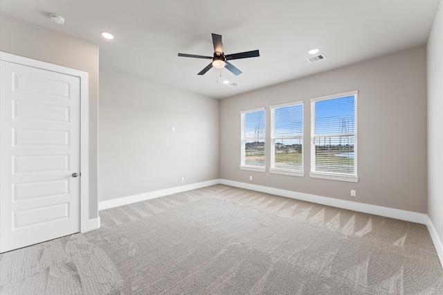 empty room featuring recessed lighting, carpet, baseboards, ceiling fan, and visible vents