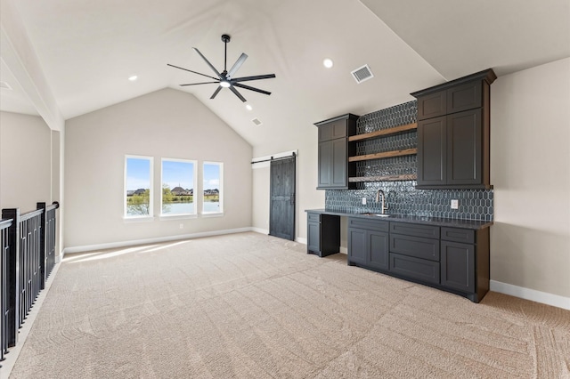 kitchen featuring backsplash, a sink, open shelves, visible vents, and ceiling fan
