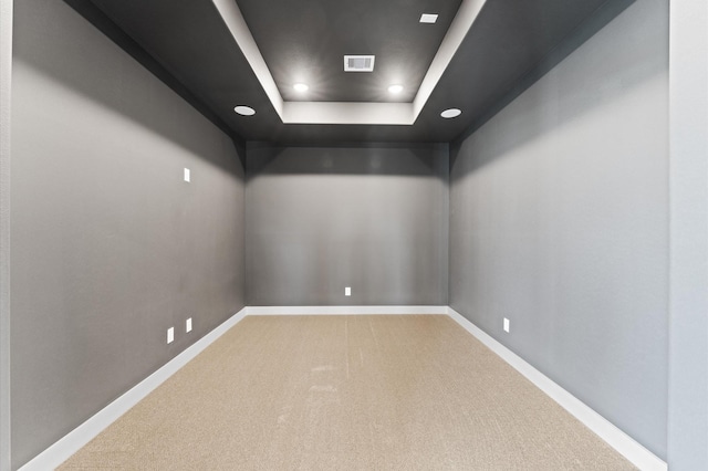 carpeted spare room with baseboards, a tray ceiling, visible vents, and recessed lighting